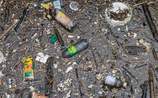 Plastic and other trash collected by a boom along a creek that drains into Lake Erie, May 1, 2026, in Erie, Pennsylvania. (Brian Cassella/Chicago Tribune)