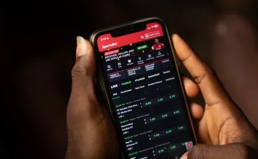 Lugbe, Abuja-Nigeria - April 22nd 2024: african person using sportybet app for sports betting