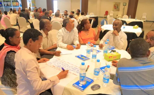 Participants engaged in group discussions, analyzing Pulitzer Center reporting on climate change, food insecurity, and civilian protection