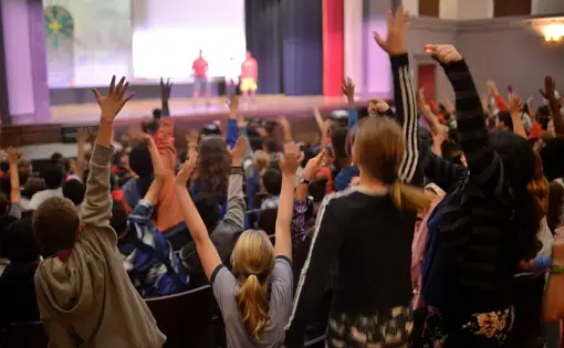 Eager students volunteer to participate in acrobatics onstage. Image by Dermot Tatlow. United States, 2018.