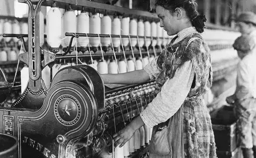 A young girl works the spinning machines, Lewis Hine, Cherryville, NC, 1908.