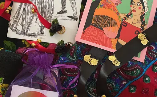 Items including decorated ribbons, cards, and a colorful dikhlo scarf.
