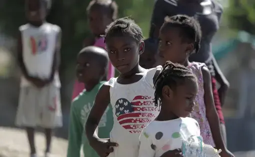 A group of children checks out visitors at the Teren Toto camp in Haiti. Image by Jose A. Iglesias. Haiti, 2019.
