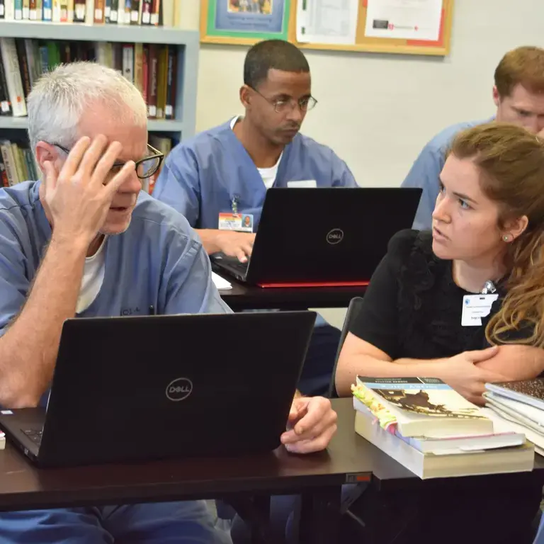 Cramer_photo.jpg Classroom photo. Educator with incarcerated students.