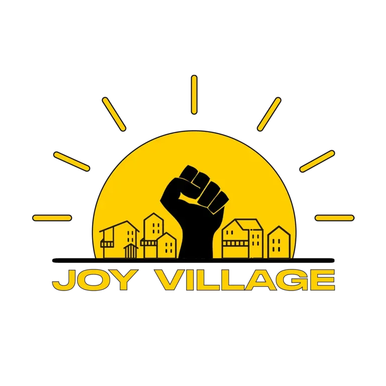 Joy Village Logo - Black Power fist, surrounded by buildings in the center of a sun, with the text 'Joy Village' underneath