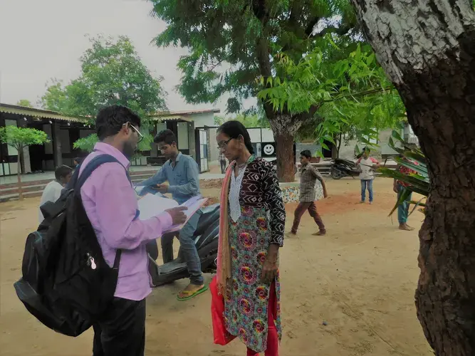 Health coordinator Ajay Vaghela and health worker Modi Niven compare notes at one of the local Manav Sadhna schools. Image by Ambar Castillo.&nbsp;India, 2017.