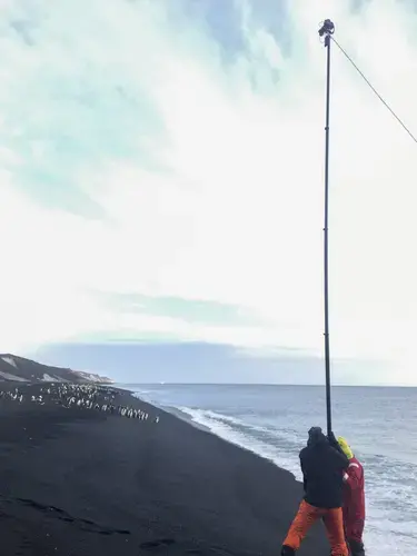Mr. Steinmetz sets up a pole in Antarctica to capture a penguin colony in Dec. 2017. Image Courtesy of George Steinmetz. Antarctica, 2017.