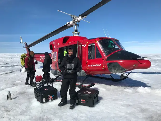 Mr. Steinmetz holds the controls to his drone in Greenland in July 2017. (This photo was taken with the drone.) Image by George Steinmetz. Greenland, 2017.