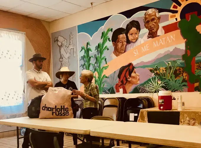 Sister Beatrice Donnellan speaks with a pair of El Pasoans donating clothes.&nbsp;Image by Lily Moore-Eissenberg. United States, 2019.