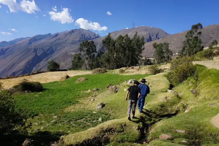 Gabino leads Clinton as the two observe their changing land. Image by&nbsp;Audrey Fromson. Peru, 2019.&nbsp;