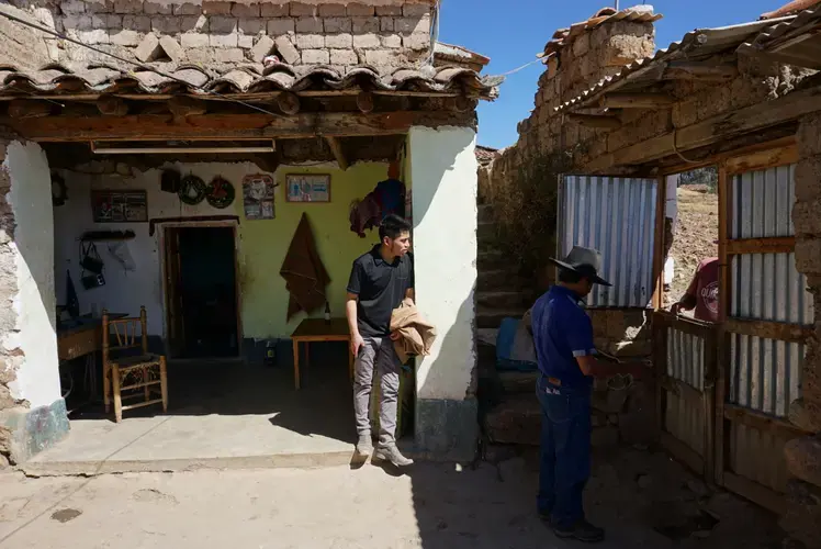 Clinton (center) works in Huaraz, but makes the three-hour journey to visit his parents in their village once a month.&nbsp;Image by Audrey Fromson. Peru, 2019.