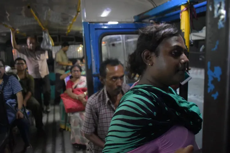 Sintu, like many transgender individuals,&nbsp;relies on street economies&nbsp;such as dancing for survival. Traveling all across Kolkata, she spends a large portion of her life on public transportation. Buses and trains across India are divided by gender&nbsp;with painted signs. There is only standing room on this bus, but she always sits in the 'Gentlemen's' section.&nbsp;Image by Siyona Ravi. India, 2017.