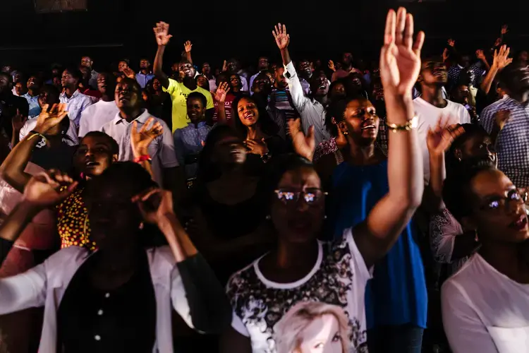 Worshippers sing during a Sunday service at Watoto church, an English speaking Pentecostal church, in downtown Kampala. Activists say Watoto, led by American pastor Gary Skinner, &nbsp;has been instrumental in spreading homophobia, including through hosting American evangelical Scott Lively.&nbsp;Image by Jake Naughton. Uganda, 2017.