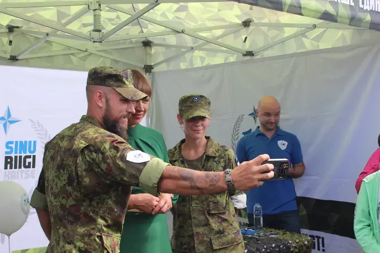 The Estonian president posing for a&nbsp;selfie with Estonian soldiers&nbsp;in Tallinn on Independence&nbsp;Restoration Day.&nbsp;Image by Hani Zaitoun. Estonia, 2019.