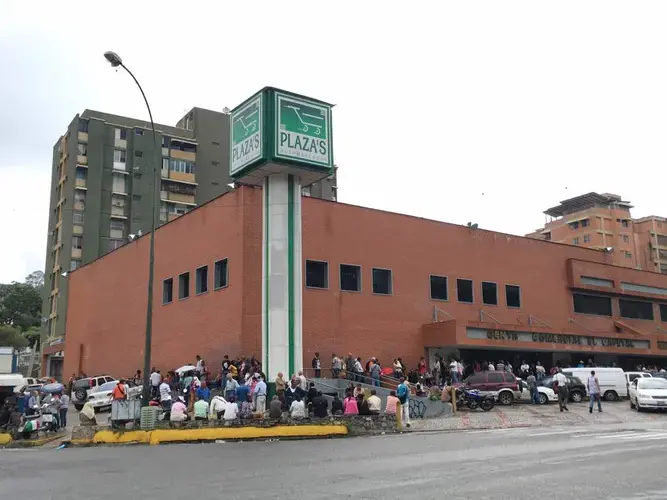 Long line of people wait to enter Plaza Supermarket . Image by María González.&nbsp;Venezuela, 2017.