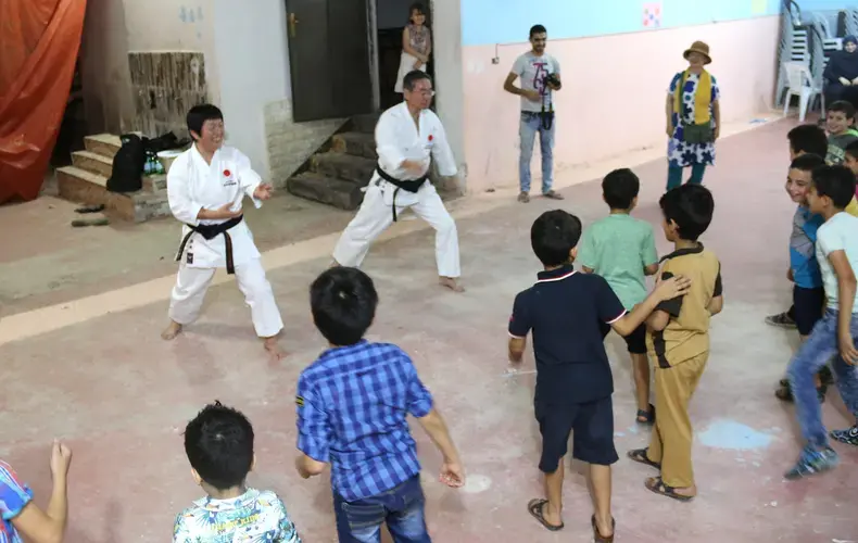 Children relieve stress at&nbsp;Homs League Abroad with various activities. Here they are practicing karate moves with a Japanese volunteer team. Image by Sawsan Morrar. Jordan, 2017.