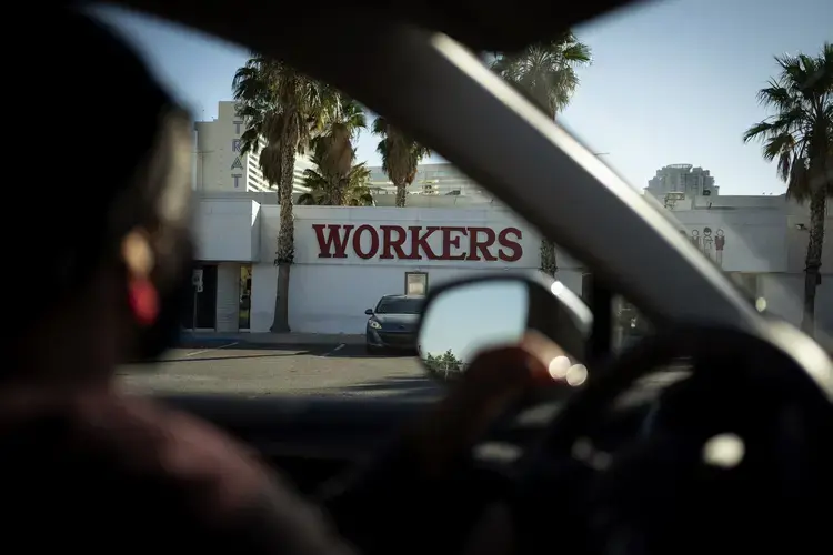 The office of the Culinary Workers Union is seen through a car window in Las Vegas, Monday, Nov. 9, 2020. The union represents 60,000 people, most of them immigrants, in the Las Vegas area who work in the hospitality industry. More than half of the members represented by the union are currently out of work due to the coronavirus pandemic. Image by Wong Maye-E / AP Photo. United States, 2020.