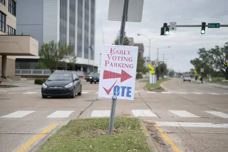Signs official and handmade encouraging voter turnout plaster the streets of Lake Charles amidst the destruction from back-to-back Hurricanes Laura and Delta and a slow recovery due to COVID-19. Image by Katie Sikora. United States, 2020.