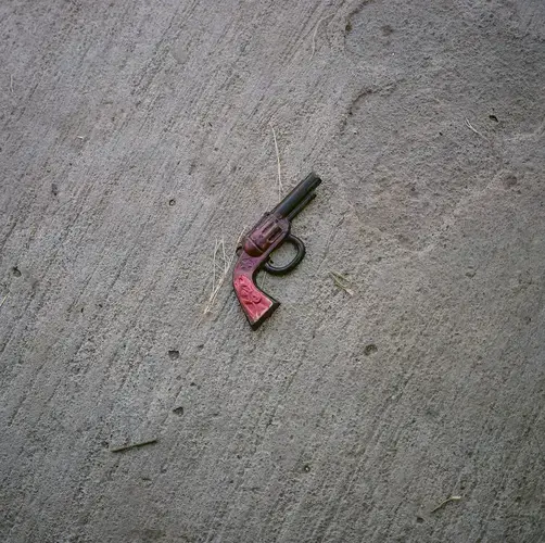 A toy gun is seen in front of the home of Reyna Patricia Ambroz Zapatero, September 25, 2020.&nbsp;Image by by Christopher Lee. Mexico, 2020.