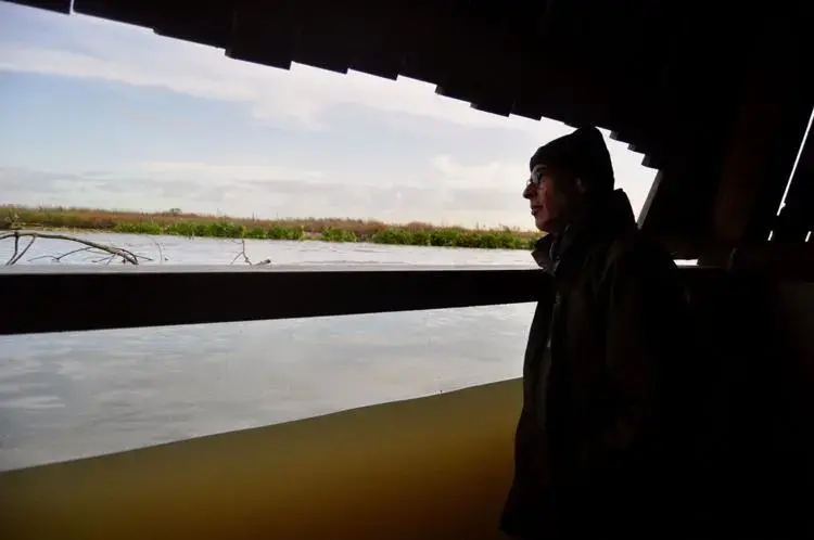 Roel Posthoorn, director of the Marker Wadden, looks out from a partially submerged shelter on an artificial island north of Amsterdam.&nbsp;Image by Tristan Baurick / Times-Picayune | The Advocate. The Netherlands, 2020.