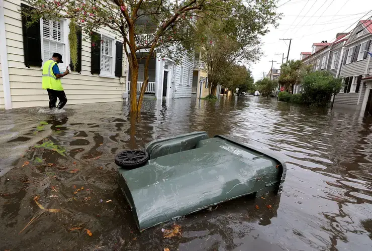 Keith Davis, who works at Ashley Hall, films the flooding from heavy rains on Vanderhorst Street on Friday, Sept. 25, 2020, in Charleston. Image by Grace Beahm Alford /&nbsp;Post and Courier. United States, 2020.
