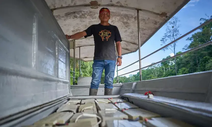 Nantu shows the battery pack of one of the solar-powered canoes. Image by Pablo Albarenga. Ecuador, 2020.