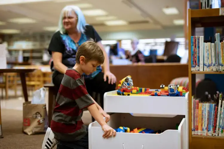 Anna Koski and her grandson Aiden spending time in the downtown library in Miami, Oklahoma. Photo by Destiny Green. United States, 2020.