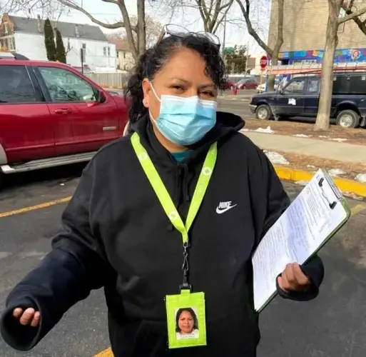 Martina Sanchez, a promotora de salud, stands outside a Back of the Yards laundromat where she shared information with and fielded questions from residents about COVID-19. Image by María Inés Zamudio / WBEZ News.
