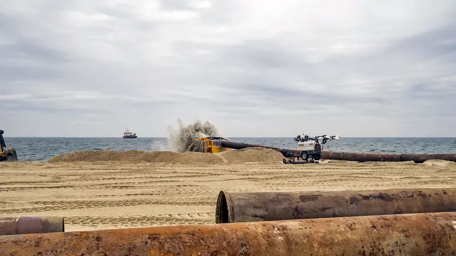 The Magdalen pumps a slurry of sand and seawater onshore, where it is filtered through an elevator-car-sized cage called a “basket.” Image courtesy of NJ Spotlight. United States, undated.