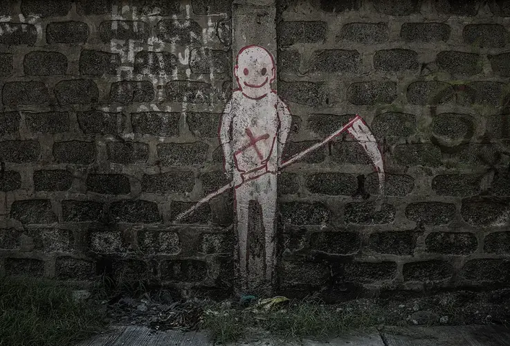 Graffiti on a wall next to a bridge in Navotas where victims of extrajudicial killings were thrown off of into a canal. Image by James Whitlow Delano. Philippines, 2017.