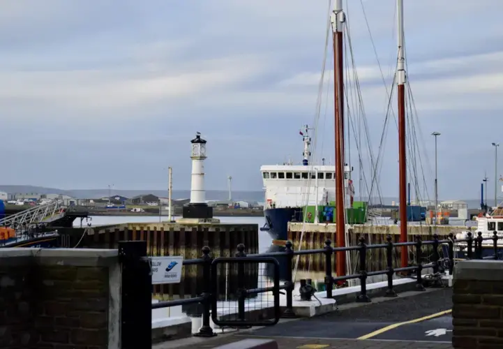 The Kirkwall Orkney Ferry Terminal is where people get ferries to many of the smaller islands around the mainland. Though there aren't many wind turbines near the ferry terminal because the area is relatively populated, wind turbines on other parts of the island are visible from Kirkwall. Image by Maggie More. United Kingdom, 2020.