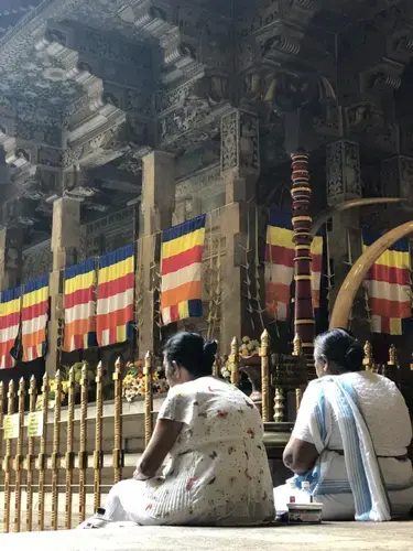 Women at the Temple of the Tooth in Kandy. Image by Sarah Hoenicke. Sri Lanka, 2018.