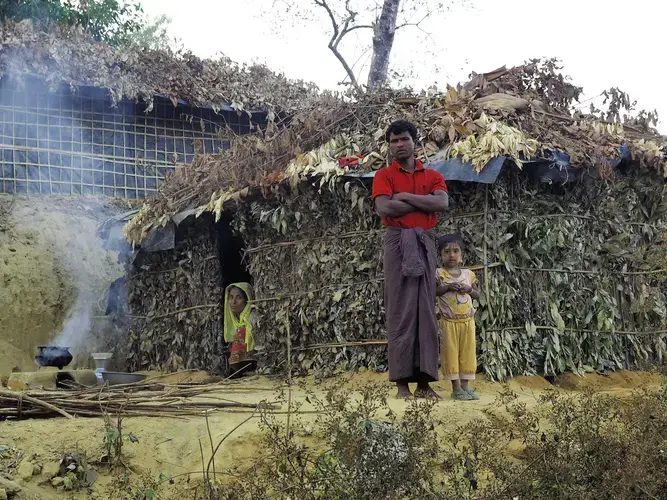 A family with their newly constructed shelter outside Balukhali Refugee Camp. Image by Doug Bock Clark. Bangladesh, 2017.
