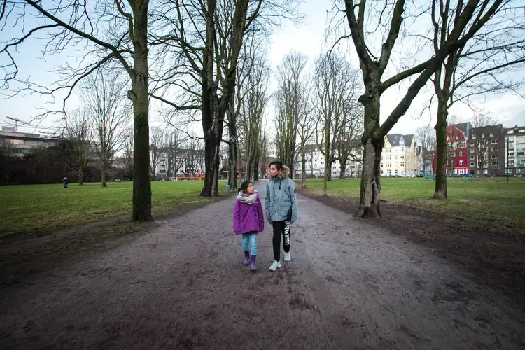 Milad (right) with his sister Mahya at the Frankenplatz park near their shelter in Düsseldorf. Image by Diana Markosian. Germany,&nbsp;2017.