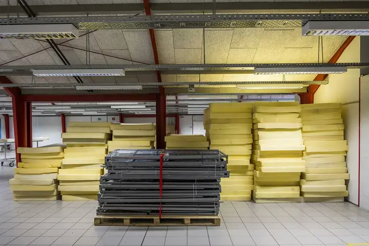 The refugee camp in Sumte in September 2016, after the last refugee had left. Employees have stacked the camp mattresses in one of the former bedrooms. Many refugees left of their own accord in the spring and summer; others were relocated into larger towns. Image by Valerie Schmidt. Germany, 2017.