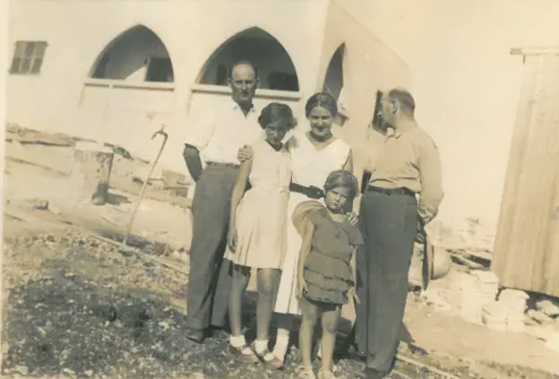 Shula Lavyel and her younger sister, Avivit, with their father (right) and his two siblings, in front of their house in Haifa being built.&nbsp;Image courtesy of Shula Lavyel.&nbsp;British Mandate of Palestine, 1935.