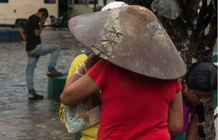 Each morning, small-scale miners gather at the central square of El Callao. Depending on weather conditions and demand in the mines, they are offered day jobs. If they don’t find work, they often simply spend their days searching the local rivers with their washing boards. Image by Bram Ebus. Venezuela, 2017.<br />