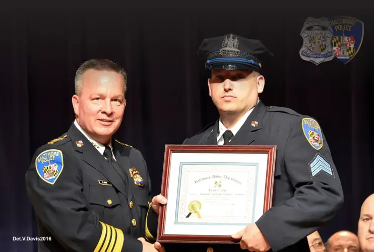 Jenkins, shown here with then-Commissioner Kevin Davis, was awarded a bronze star in April 2016 for his efforts to save injured officers during the unrest a year earlier. Baltimore, Maryland. April 2016. Image by Baltimore Police Department.