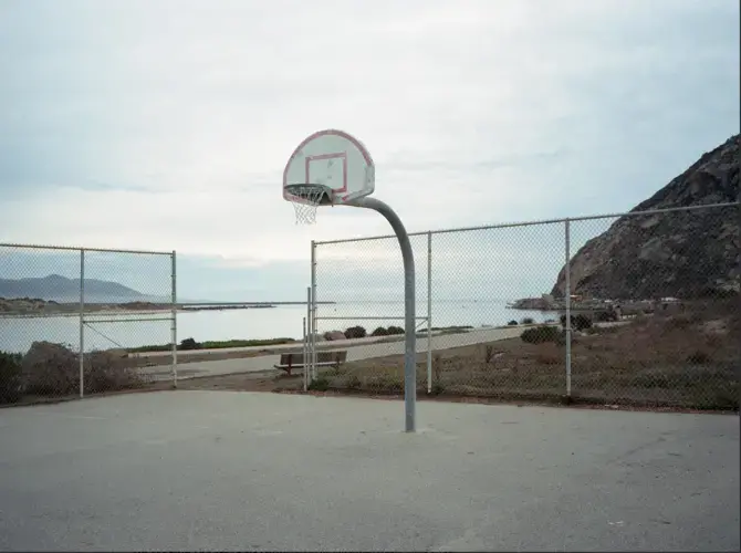 View of Morro Bay, California, from the basketball court. In California, land seized from the Chumash, Yokuts, and Kitanemuk tribes by unratified treaty in 1851 became the property of the University of California and is now home to the Directors Guild of America. Image by Kalen Goodluck / High Country News. United States, 2020.