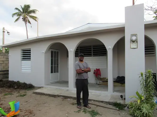 Guillermo Carmona after his home was repaired by the Ricky Martin Foundation. Image courtesy of Kari Lydersen, Isabel Dieppa, and Martha Bayne. Puerto Rico, 2019.
