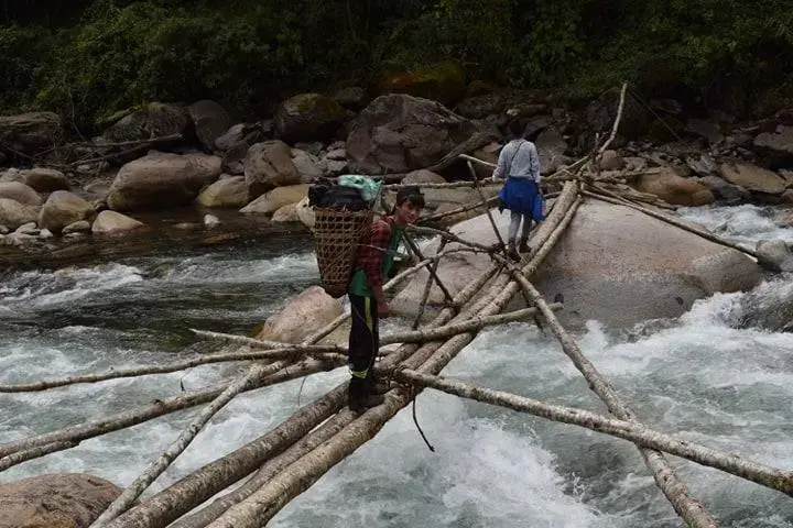 Local villagers cross a stream in Hkakabo Razi National Park. Image by Sanlu Ram Seng | Frontier. Myanmar, 2019.