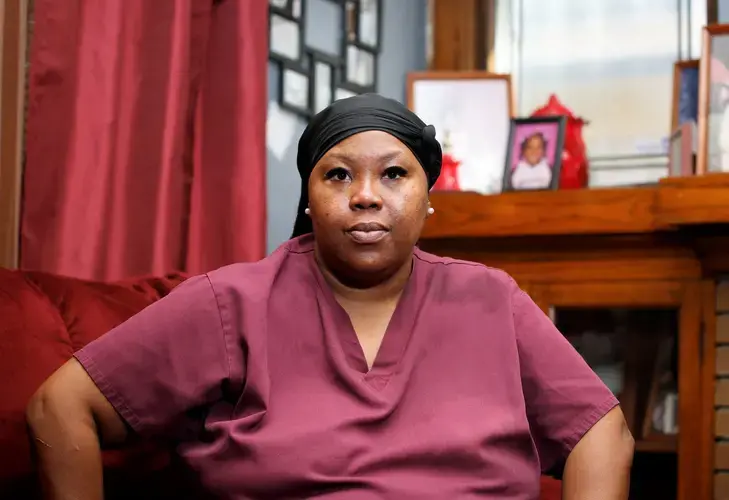 Wyconda Clayton sits in the living room of her Milwaukee duplex, which is owned by Business Ventures Investments. Image by Pat A. Robinson. United States, 2020.