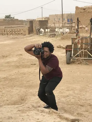 Gavin McIntyre takes a photo with a DSLR camera.