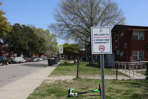A neighborhood street sign that reads "Welcome to Young Terrace A smoke free community."