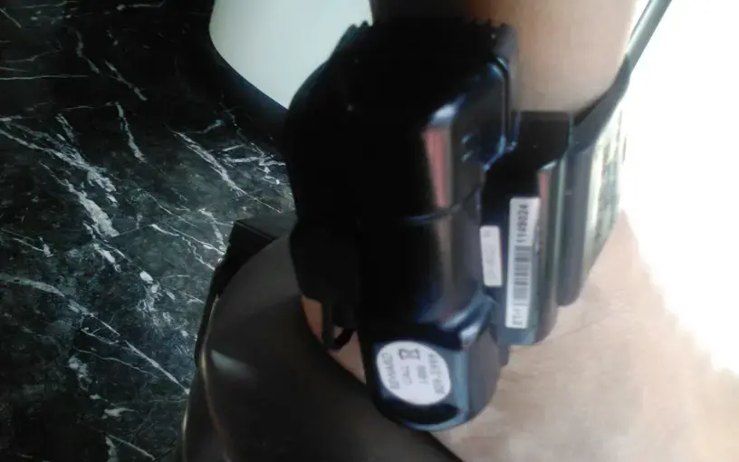A close up of a black ankle monitor.
