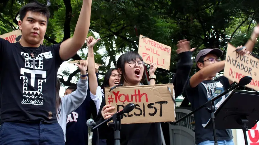 Shibby de Guzman, 13, center, joins other youths Tuesday at a Manila rally to protest policies of the Duterte government. Image by Ana P. Santos. Philippines, 2017.