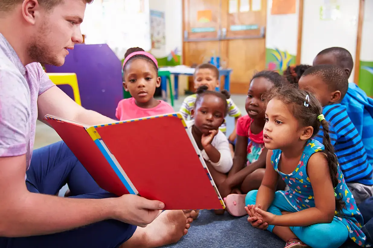 Nursery school children in South Africa are taught by a volunteer teacher. Image by Rex/Shutterstock.