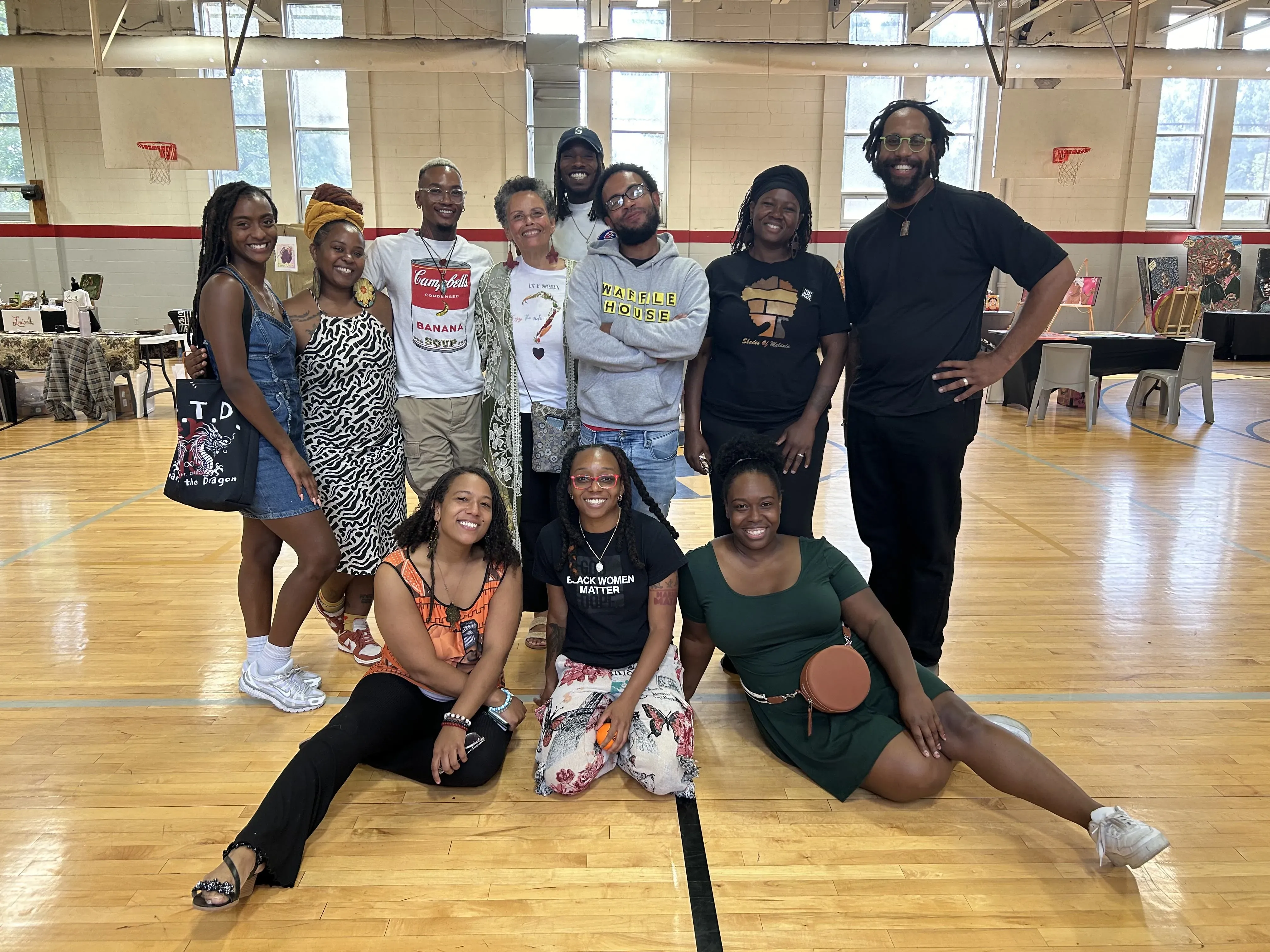students and coach pose for photo on basketball court