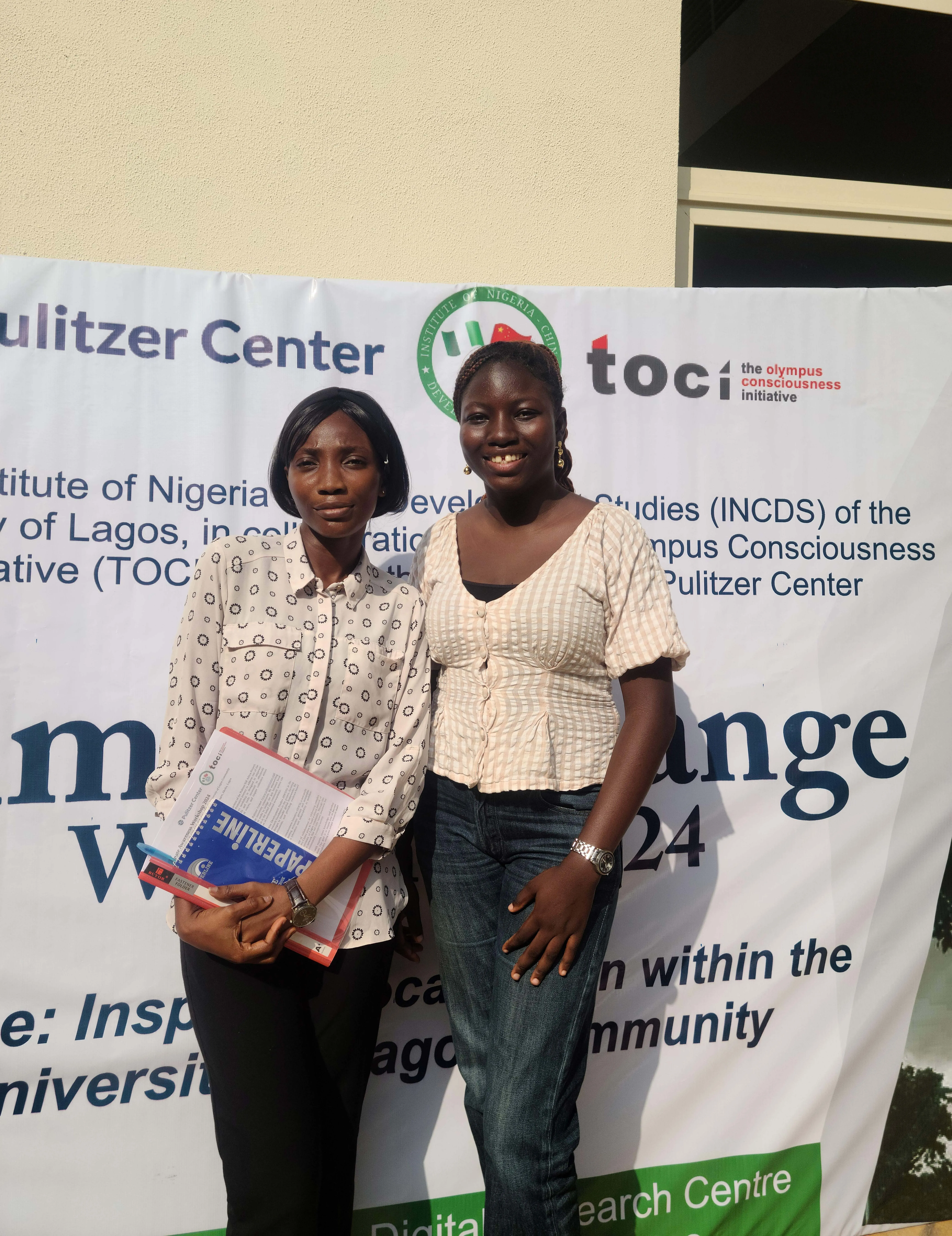 two people smile for a photo at a climate workshop at University of Lagos