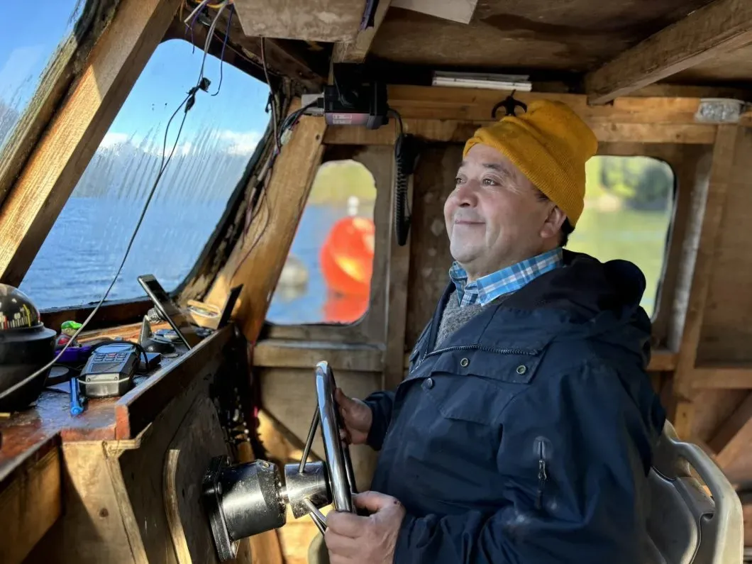 Boris Hernández on his boat in Comau Fjord. Muriel Alarcón
